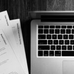 Best expense tracking tool for freelancers displayed on a laptop with receipts on a desk in 2026