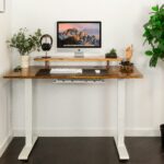 Best standing desk raised to standing height in a clean modern home office in 2026