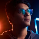 Man wearing blue light blocking glasses with blue light reflections in 2026