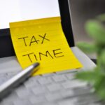Best tax software open on a laptop alongside financial documents during tax filing season in 2026