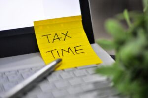 Best tax software open on a laptop alongside financial documents during tax filing season in 2026