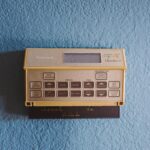 Home security system keypad and control panel mounted on interior wall in 2026